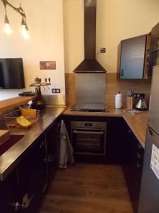 a kitchen with a stove and a counter top at Les Gîtes De Morville in Malaumont