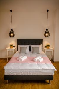 a bedroom with a large bed with two towels on it at GOLDEN ROOMS blisko Energylandii in Zator
