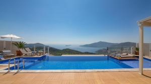 a swimming pool with a view of the ocean at Villa La Mer Azur in Kalkan