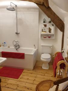 a bathroom with a white tub and a toilet at The Millers Cottage in Okehampton +76 photos