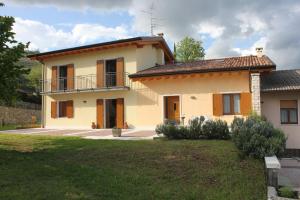 a house with a balcony on top of it at La Bella Vigna in Marano di Valpolicella