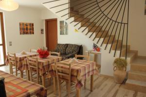 un comedor con mesas y sillas y una escalera en La Bella Vigna, en Marano di Valpolicella
