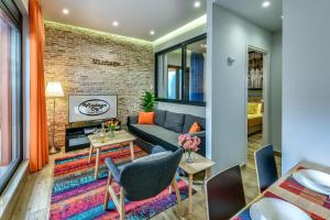 a living room with a couch and a brick wall at Vintage City Apartments in Chania Town