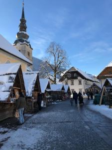 a group of people walking down a street in a market at Apartments ViTa in Kranjska Gora
