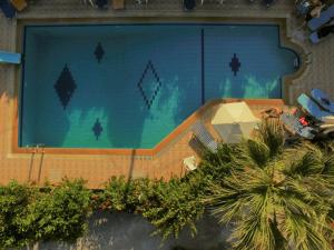 a swimming pool on the side of a building at Violetta Hotel in Amoudara Herakliou