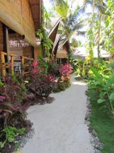 a walkway in front of a building with plants at Latitude 10 Siargao in General Luna