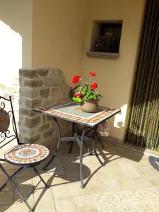 a table with a potted plant on a patio at Il Castellare in Gualdo Tadino