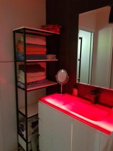 a bathroom with a pink sink and a mirror at Tambo Tranquility in Mount Tamborine