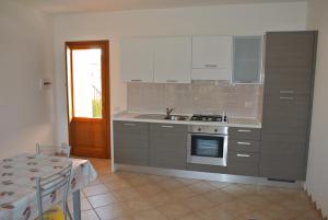 A kitchen or kitchenette at Residence Le Zagare