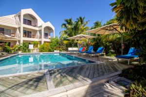 a villa with a swimming pool and a resort at Tres Cocos Resort in San Pedro