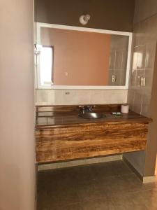 a bathroom with a sink and a mirror at Hotel El Pacifico in Morelia