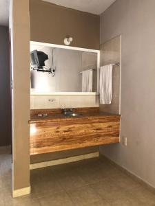 a bathroom with a sink and a mirror at Hotel El Pacifico in Morelia