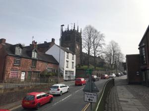 a city street with cars parked on the road at BEAUTIFUL TERRACE COTTAGE HOME, 3 BEDROOM HOUSE near Alton Towers, LEEK Centre, Peak District on doorstep in Leek