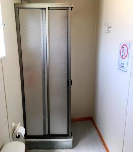 a glass shower in a bathroom with a toilet at Casa Ollagua in Vicuña