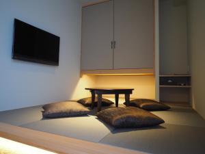 a dining room with a table and two pillows at Hotel Grand Vert Kyu Karuizawa in Karuizawa