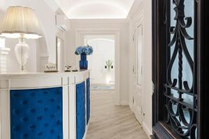 a hallway with a blue and white room with a table at Residenza Zanardelli in Rome