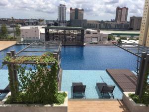 a view of a swimming pool on top of a building at USJ One HomeStay @ Subang HomeStay in Subang Jaya