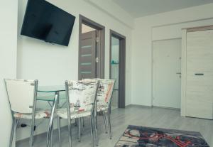 a dining room with a glass table and two chairs at Apartament #LUNA MAMAIA N in Mamaia Nord
