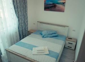 a small bedroom with a bed with a white block on it at Apartament #LUNA MAMAIA N in Mamaia Nord