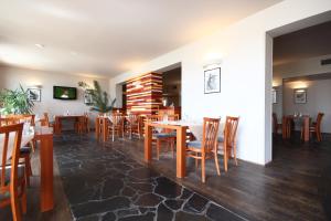 a dining room with wooden tables and chairs at Hotel Maroli Mikulov in Mikulov