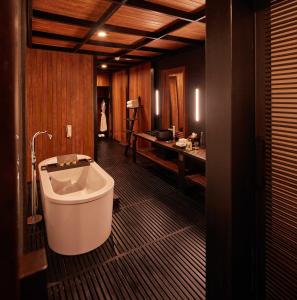 a large bathroom with a tub and a sink at Taj Exotica Resort & Spa, Andamans in Havelock Island