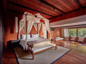 a bedroom with a bed with a canopy at Taj Exotica Resort & Spa, Andamans in Havelock Island