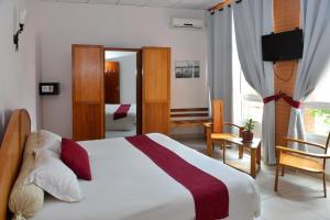 Postel nebo postele na pokoji v ubytování Zomatel Hotel