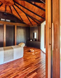 a bedroom with a bed and a wooden floor at Taj Exotica Resort & Spa, Andamans in Havelock Island