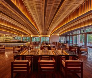 a large dining room with wooden tables and chairs at Taj Exotica Resort & Spa, Andamans in Havelock Island