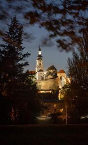 a building with a clock tower on top of it at Penzion PKO Nitra in Nitra