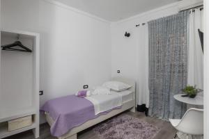 Ein Bett oder Betten in einem Zimmer der Unterkunft Guest House Tomasi One