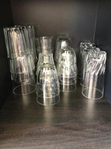 a group of glass containers sitting on a table at Résidence ATHOS C2-1 Chambre-ALPE D'HUEZ-Centre Station in L'Alpe-d'Huez