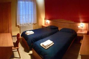 Postel nebo postele na pokoji v ubytování Lozzo di Cadore - Dolomiti - Piazza IV novembre