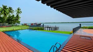 a swimming pool with a view of the water at Kent Baywatch Suites in Cochin