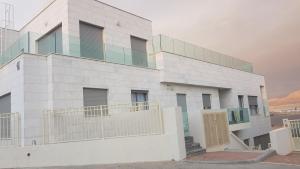 a white building with a balcony on the side of it at villalis bay view in Eilat