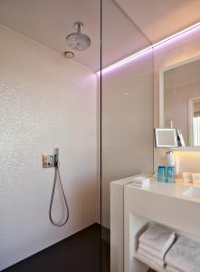 
a bathroom with a shower, sink, and mirror at ABC Hotel in Blankenberge
