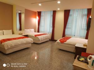 Postel nebo postele na pokoji v ubytování Sun Moon Lake Crown Yu Hotel
