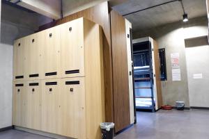 a row of wooden lockers in a room at bangkok bed place in Bangkok
