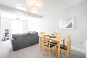 a living room with a table and a couch at The place to be - with off road parking! in Swansea