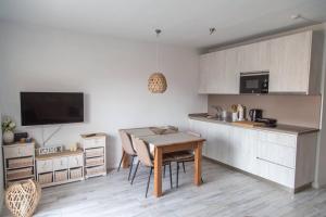 a kitchen with a small table and a kitchen counter at AstroSunrise in Los Cancajos