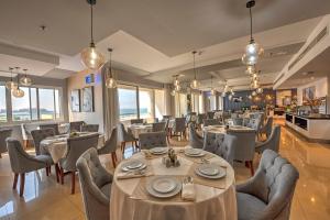 a restaurant with tables and chairs in a room at City Stay Beach Hotel Apartments - Marjan Island in Ras al Khaimah