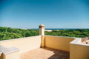 a lighthouse on the balcony of a house at Casa da Praia Verde in Praia Verde