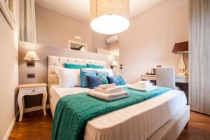 a bedroom with a large bed with blue pillows at Dream House Pompei in Pompei