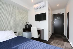 a hotel room with a bed and a desk at HOTEL LiVEMAX Minamihashimoto Ekimae in Sagamihara +15 photos