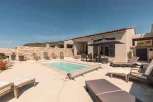 a backyard with a swimming pool and a house at Le Domaine De Marie in Palasca