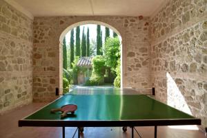una mesa de ping pong en una sala de piedra con una pista de ping pong en Chiarentana, en Chianciano Terme