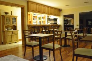 a bar with wooden tables and chairs in a room at Alma Andina Hosteria in Villa La Angostura +52 photos