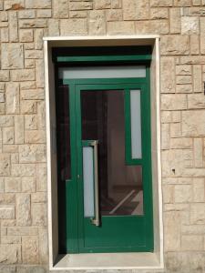 una puerta verde en una pared de ladrillo en GASCON7.4, en Teruel