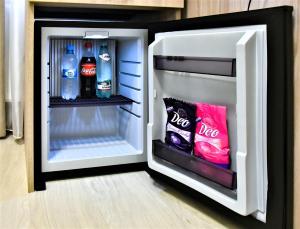 an open refrigerator with soda and drinks in it at EXPO Hotel Comfort in Kyiv