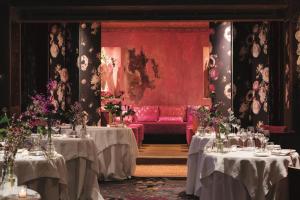 a dining room with two tables and a red couch at Hotel Metropole Venezia in Venice